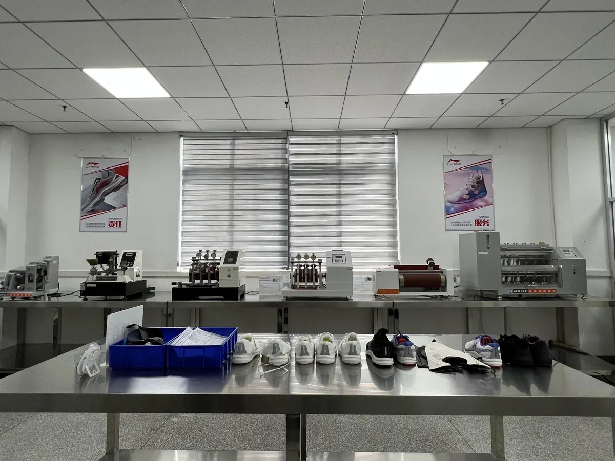 Row of GOTECH physical-testing instruments with sample shoes on the bench