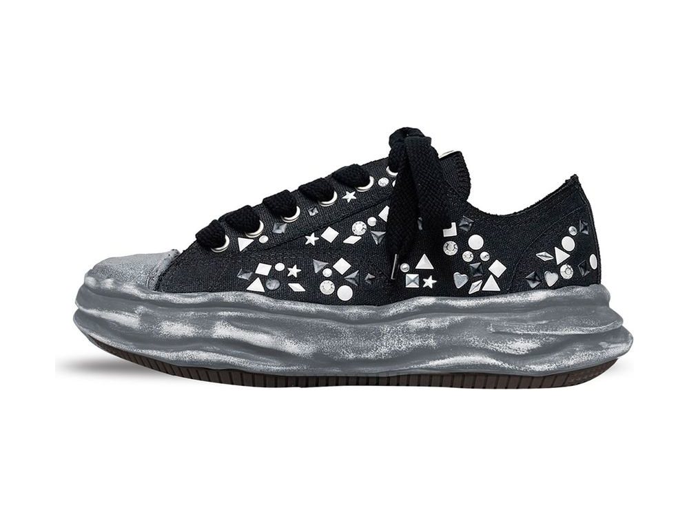 OEM/ODM black canvas low-top sneaker studded with assorted silver shapes and rhinestones, wide flat black laces and a distressed silver-painted wavy chunky midsole, manufactured by DOING Footwear