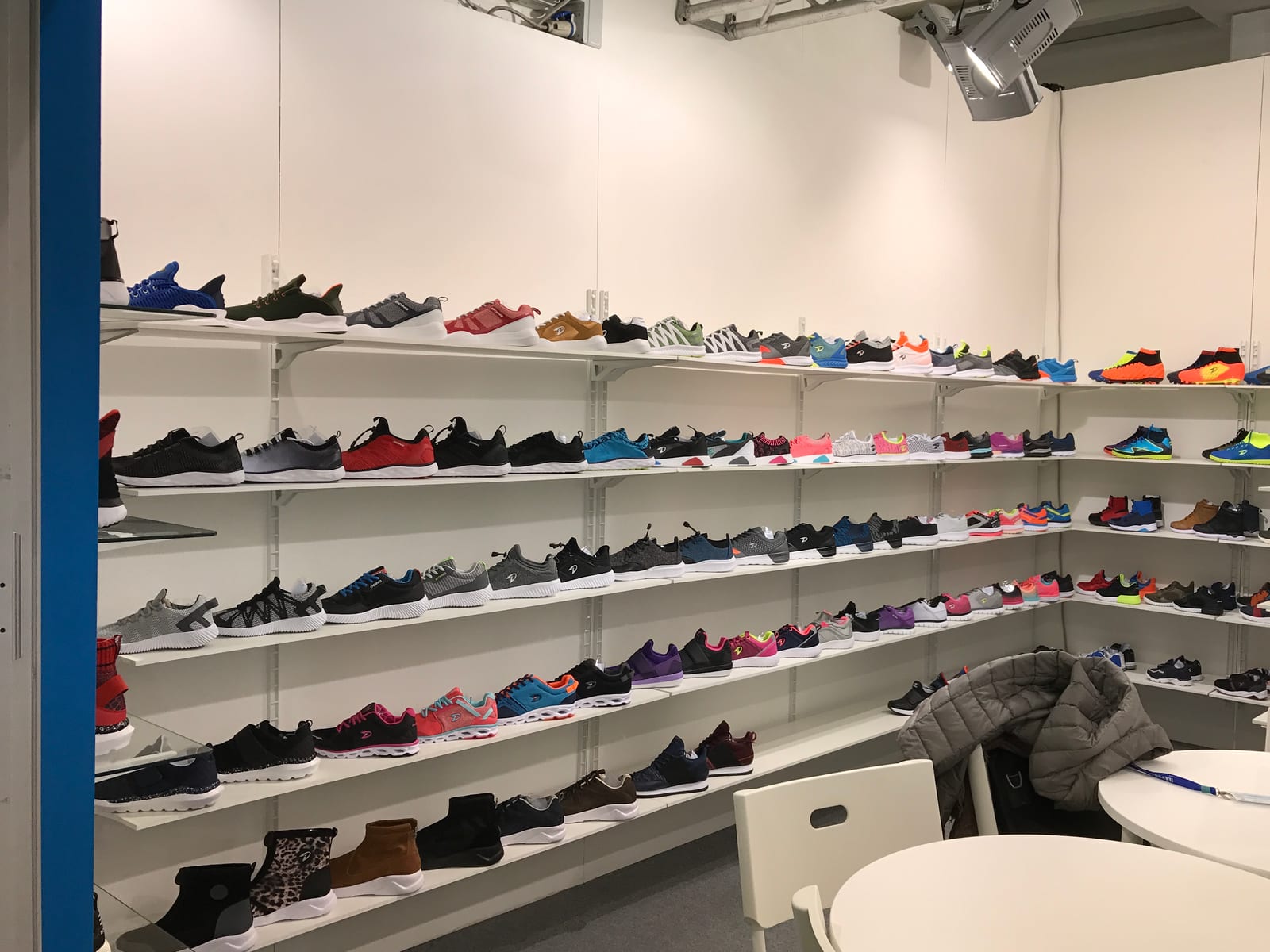 Sneaker and boot samples on display inside the DOING Footwear stand at Expo Riva Schuh, Riva del Garda, Italy